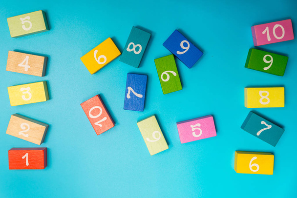 colored cubes with numbers on a blue background - Fotoğraf, Görsel