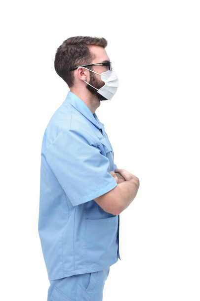 confident male doctor in surgical mask. isolated on white - Φωτογραφία, εικόνα