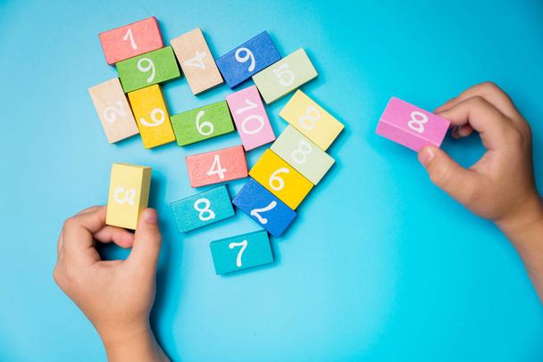 colored cubes with numbers hands - 写真・画像