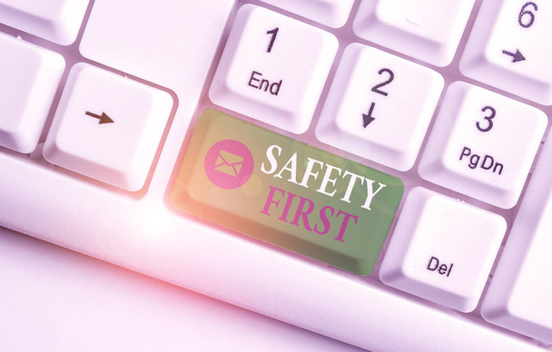 Word writing text Safety First. Business concept for said to mean that it is best to avoid any unnecessary risks White pc keyboard with empty note paper above white background key copy space. - Photo, Image