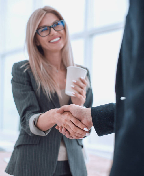 young businesswoman with a Cup of coffee welcomes her colleague - Photo, image
