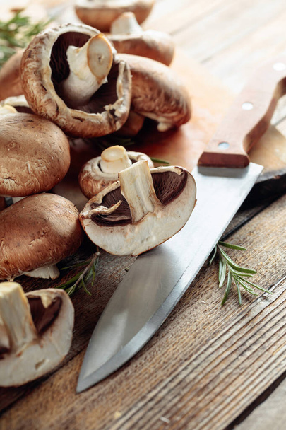 Fresh mushrooms champignon on a old wooden table.  - Valokuva, kuva