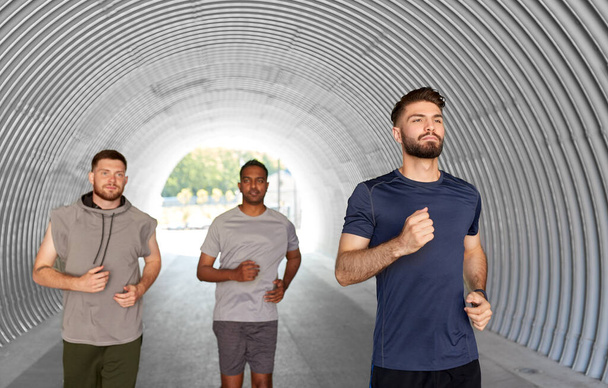 young men or male friends running outdoors - Foto, Imagen