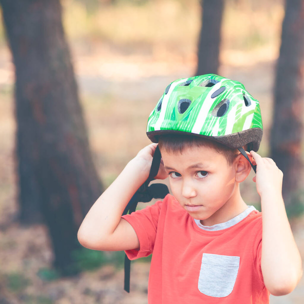 A boy wearing a helmet for cycling - Fotó, kép