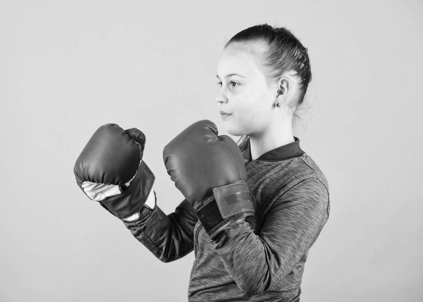 Girl cute boxer on blue background. Contrary to stereotype. Boxer child in boxing gloves. Confident teen. Enjoyment from sport. Female boxer. Sport upbringing. Boxing provide strict discipline - Zdjęcie, obraz
