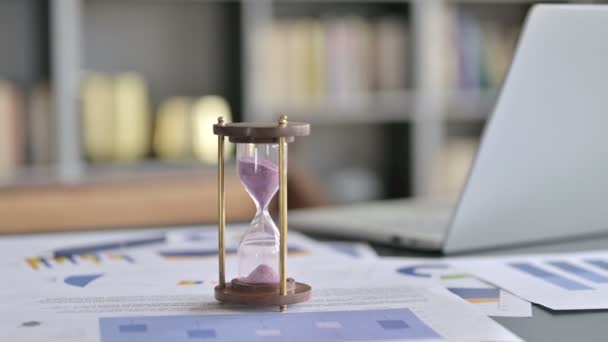 Primer plano de reloj de arena en escritorio de oficina de hombre de negocios
 - Metraje, vídeo