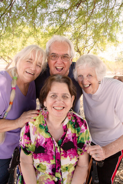 Smiling senior friends posing together outdoors on a bright day - Fotoğraf, Görsel