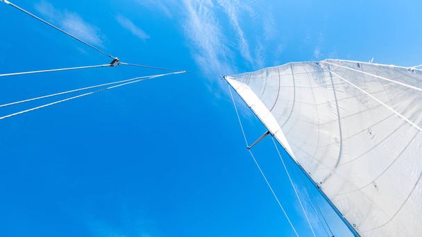 low angle view of sail boat on blue sky background - 写真・画像