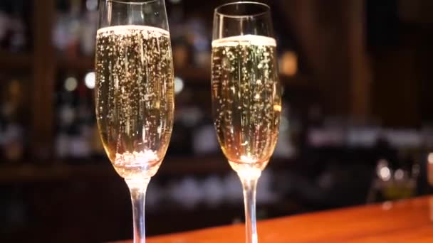 wineglass with alcoholic beverage with bubbles on unfocused background - 映像、動画