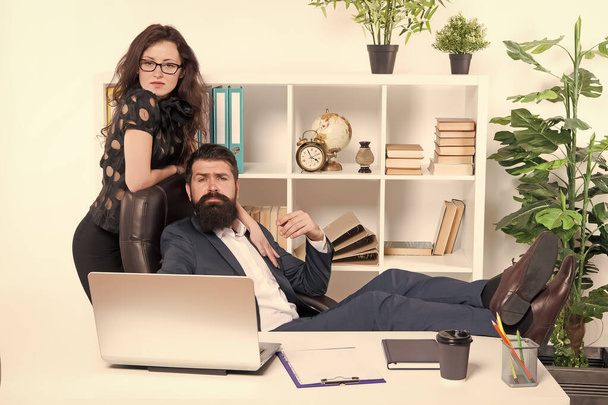 Working couple. Couple of lovers at workplace. Couple in love conducting affair at work. Romantic couple of bearded man and sensual woman in office - Фото, зображення