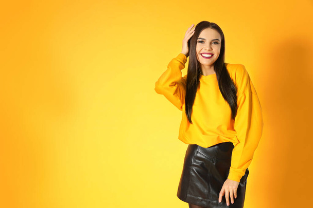 Beautiful young woman posing on yellow background, space for text. Halloween party - Foto, afbeelding