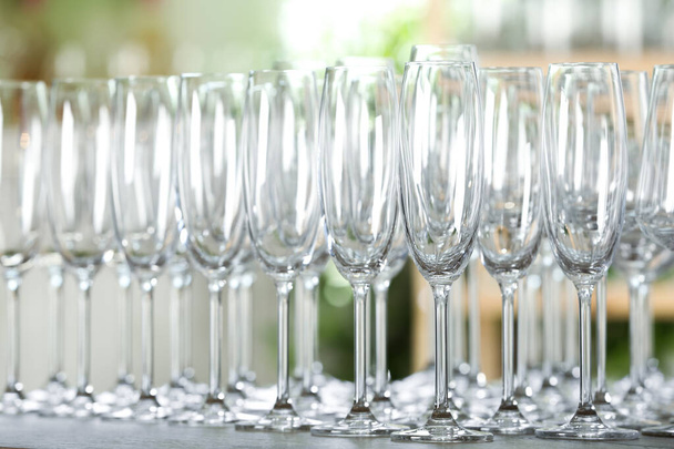 Empty glasses on wooden table against blurred background - Fotografie, Obrázek