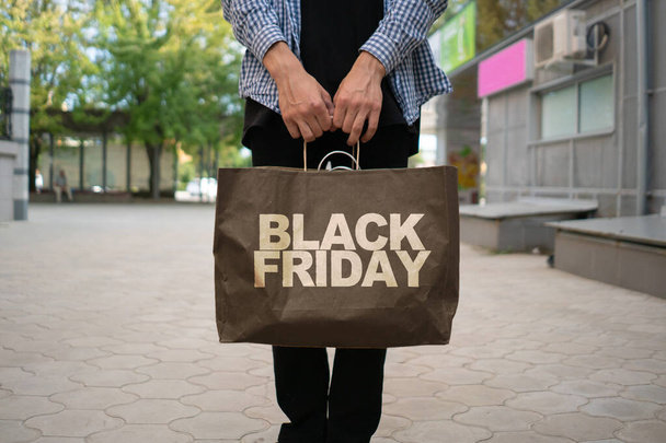 a paper bag with the Black Friday text on it. sales concept - Fotó, kép