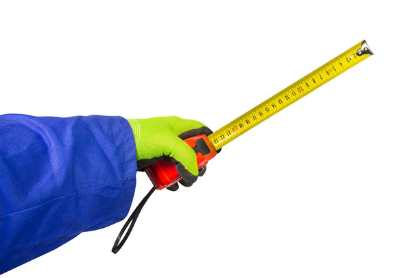 Mão de trabalhador isolada em luvas segurando roleta de medição
. - Foto, Imagem