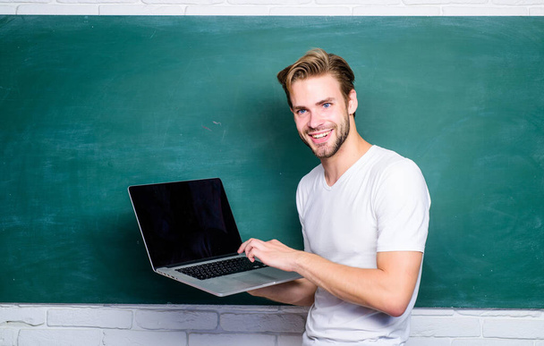 School teacher programming with laptop. Student learn programming language. Programming web development. Digital technology. Apply online course for programmers. Handsome man use modern technology - 写真・画像