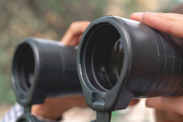 close up tourist holding binocular and searching the way, macro lens views - Photo, Image
