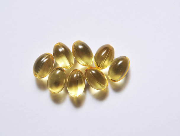 Fish fat in capsule on light background. - Photo, Image