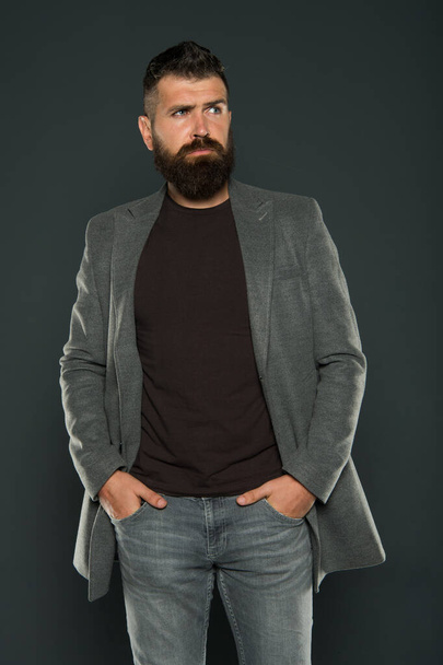 For ultimate comfort. Hipster in casual and comfy outfit keeping arms in pockets on grey background. Bearded man wear casual style. Casual and comfortable. Fashion wardrobe is casual enough - Foto, Imagem