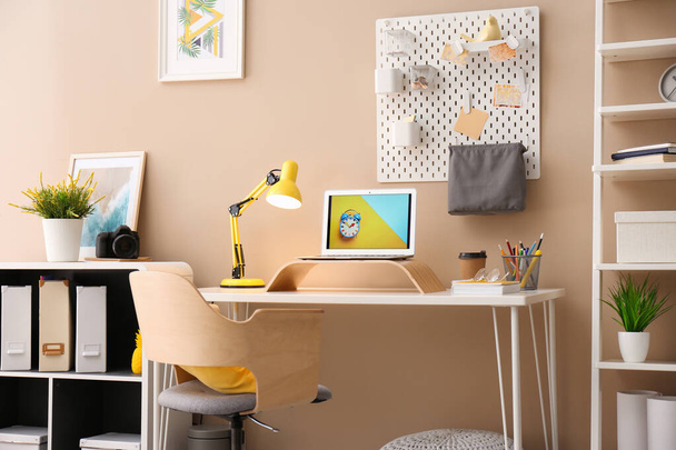 Modern laptop on desk in room. Home workplace - Foto, Imagen