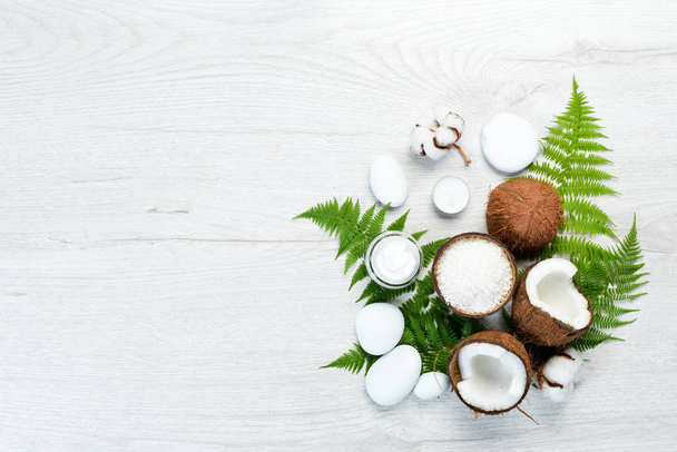 Cosmetics from coconut and coconut oil. The concept of cosmetics and spa. Top view. Free copy space. - Photo, Image