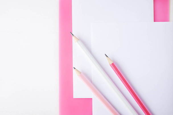 Pink clipboard, paper and group of pencils. - Foto, Imagen