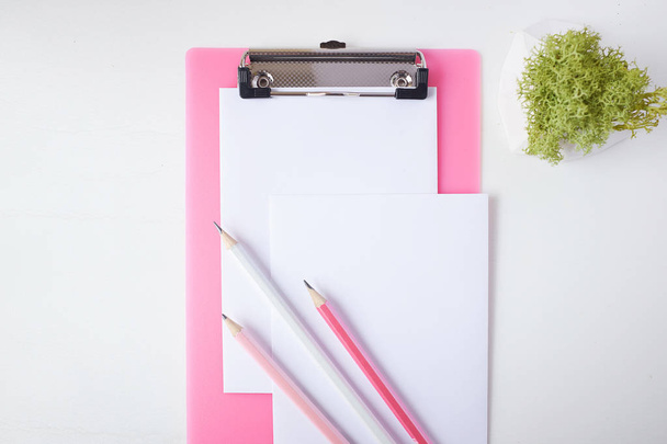 Pink clipboard, paper and group of pencils. - Foto, Imagen