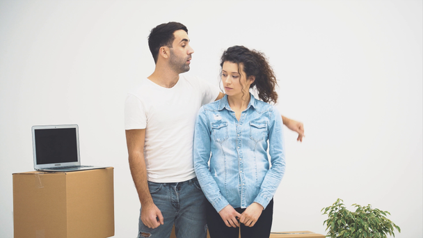 Young couple moved to a new apartment together. They are discussing some details. Couple is looking around. Copy space. Action, Animation. 4K. - Footage, Video