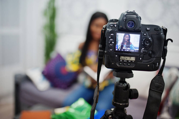 Cute african american woman making a video for her blog using a  - Foto, immagini
