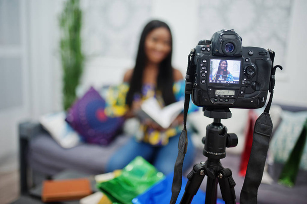 Cute african american woman making a video for her blog using a  - Photo, image