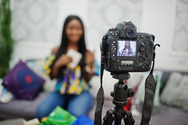 Cute african american woman making a video for her blog using a  - Fotó, kép