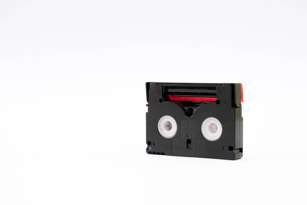 Vintage mini DV cassette tape used for recording video back in a day. Plastic, magnetic, analog film tape on white background - Photo, Image