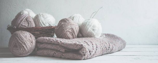 Tubes of wool thread and knitting needles for knitting handmade hobby in Scandinavian style monochrome with copy space long banner  Accessories for knitting. - Photo, image