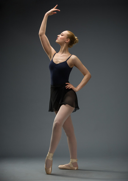 Full-length portrait of dancing ballerina with hand up - Photo, Image