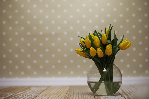 Bukiet żółtych tulipanów w wazonie na podłodze. Prezent w - Zdjęcie, obraz