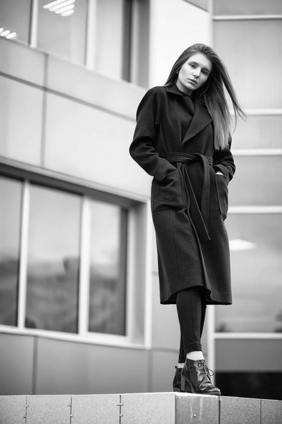 Girl in a coat black and white photo - Фото, изображение