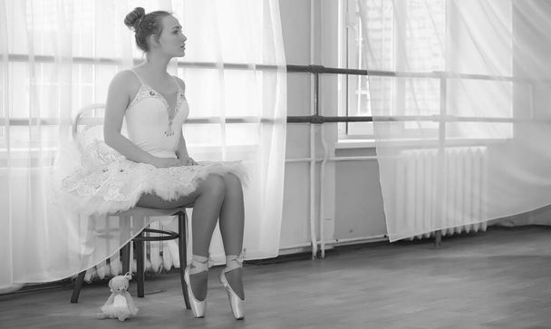 Young ballet dancer on a warm-up. The ballerina is preparing to  - Photo, Image
