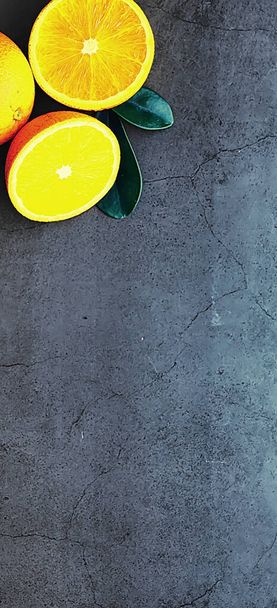 Orange citrus fruit on a stone table. Orange background. - Фото, изображение