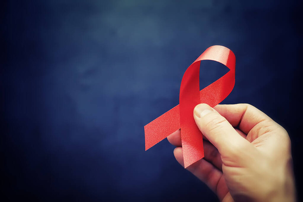 Symbol of human immunodeficiency virus disease. Red ribbon. A he - Photo, Image