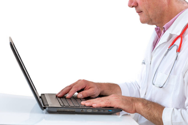 crop profile view of a Smiling doctor working on laptop at his desk. on white - Foto, Imagem