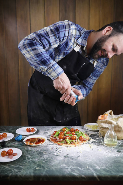 pizza hazırlama adamım, hamur ve koyar malzemeleri yoğurun - Fotoğraf, Görsel