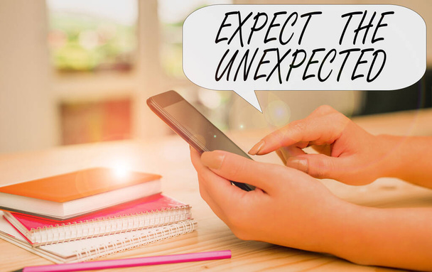 Conceptual hand writing showing Expect The Unexpected. Business photo text Anything can Happen Consider all Possible Events woman using smartphone and technological devices inside the home. - Photo, Image