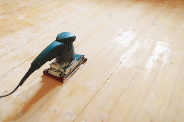 wooden floor sanding with flat sander tool - Photo, Image