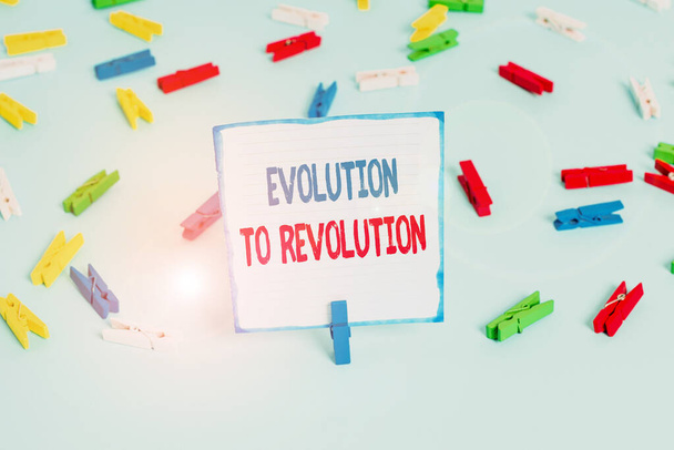 Conceptual hand writing showing Evolution To Revolution. Business photo text adapting to way of living for creatures and huanalysiss Colored clothespin papers empty reminder blue floor officepin. - 写真・画像