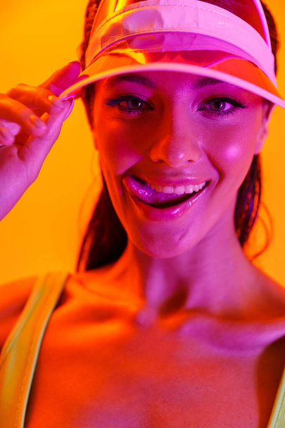 Image closeup of flirting brunette woman wearing sun visor cap a - Zdjęcie, obraz