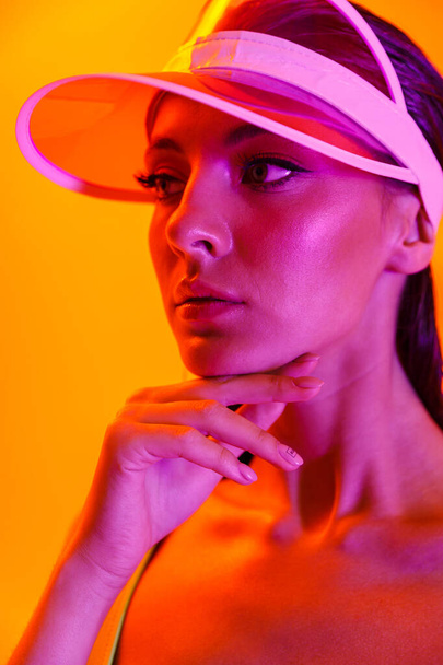 Image closeup of seductive brunette woman wearing sun visor cap  - Fotoğraf, Görsel
