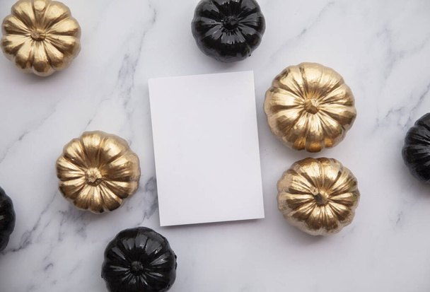 Luxury gold and black autumn pumpkin flat lay composition on a marble background - Фото, зображення