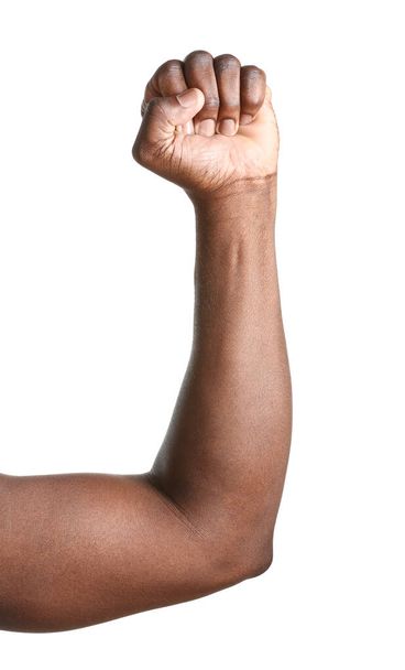 Hand of African-American man with clenched fist on white background - Фото, изображение