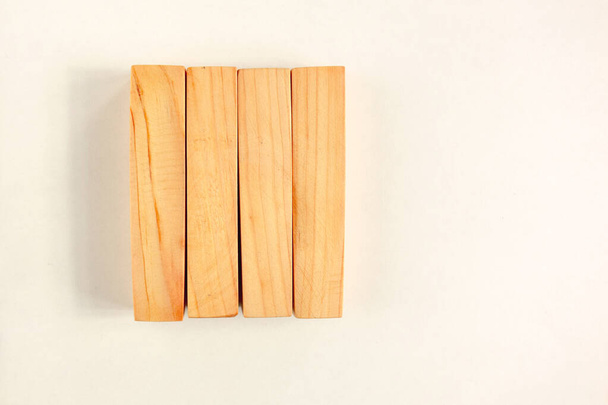 Wood bar pieces with shadows on white background. Vertical woode - 写真・画像