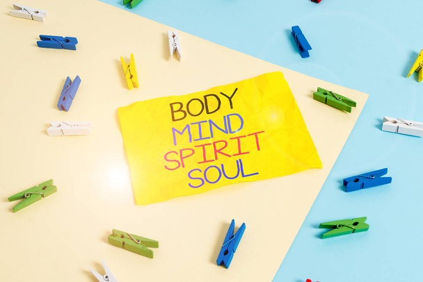 Handwriting text writing Body Mind Spirit Soul. Concept meaning Personal Balance Therapy Conciousness state of mind Colored clothespin paper empty reminder yellow blue floor background office. - 写真・画像