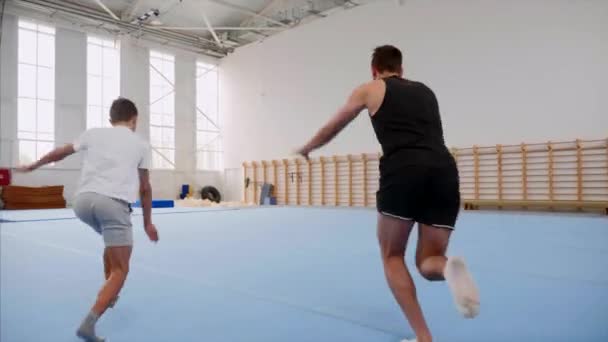 Cartwheel and tripple back flip are made by man and boy, steadicam. - Felvétel, videó